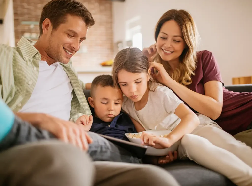 family sitting on a couch in the comfort of their own home in springfield illinois